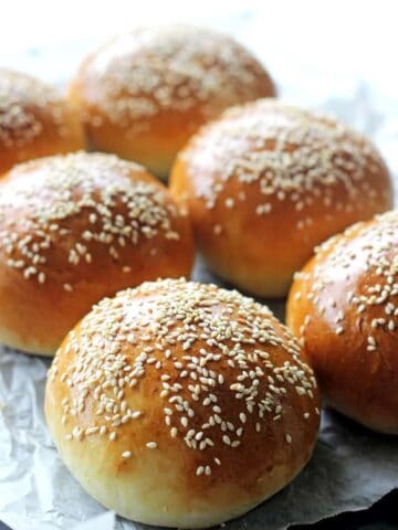 6 burger buns on a baking tray
