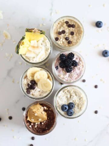 6 jars of overnight oats on a white background